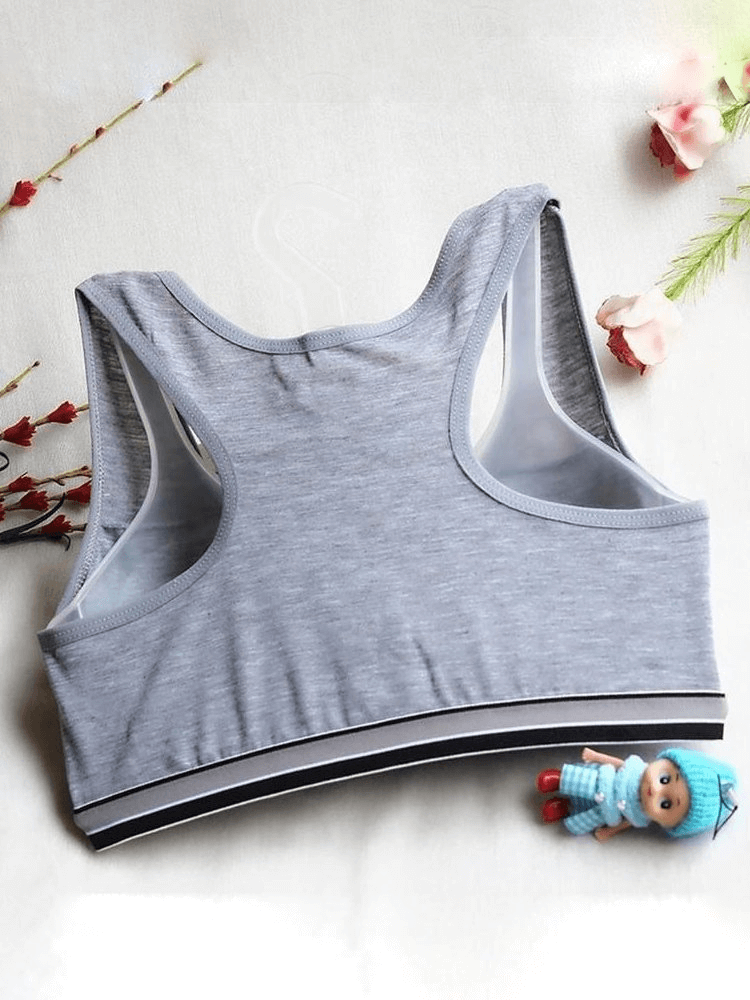 Gray sports quick-drying top-bra with elastic lining displayed on a white background, surrounded by floral accents and a small doll.